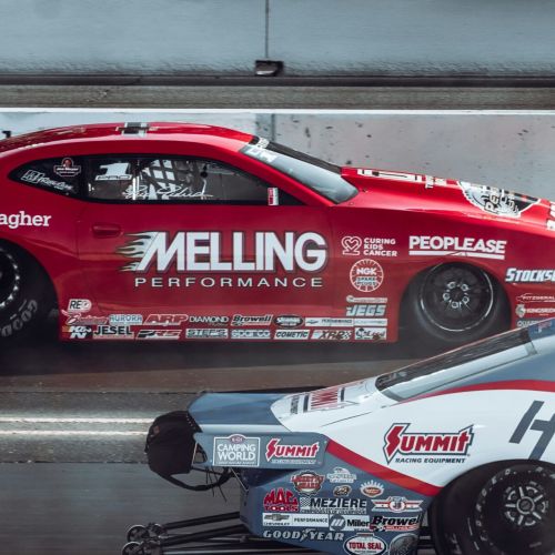 The Lodges of Huntersville Two cars race on a track, featuring the phrase "melting performance" prominently on the side of one vehicle.