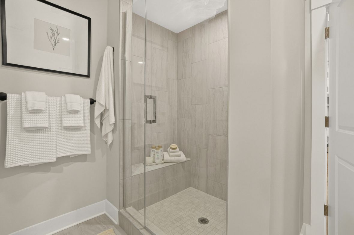 The Lodges of Huntersville A bathroom featuring a white sink and a stylish black and white tiled floor.