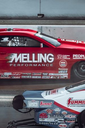 The Lodges of Huntersville Two cars race on a track, featuring the phrase "melting performance" prominently on the side of one vehicle.